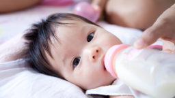 A baby is fed with a bottle