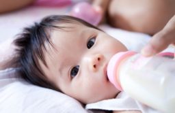 A baby is fed with a bottle
