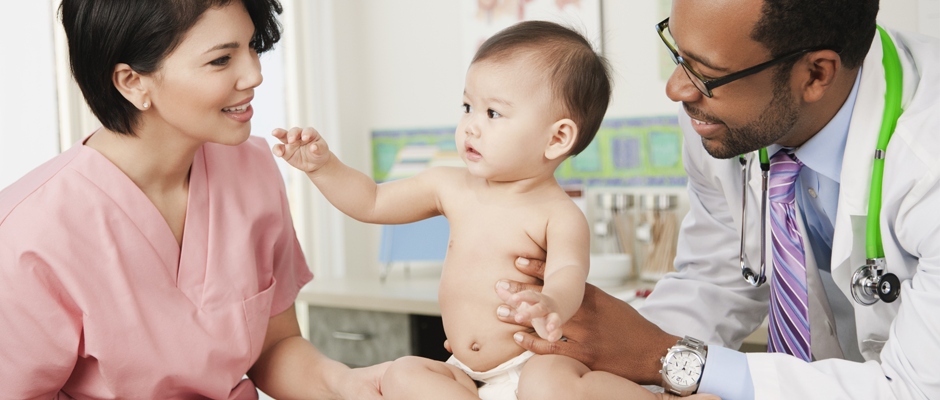 A nurse and a pediatrician examine a baby