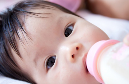 A baby is fed with a bottle