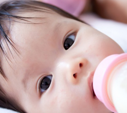 A baby is fed with a bottle