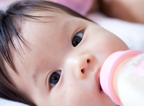 A baby is fed with a bottle