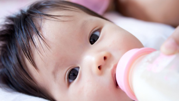 A baby is fed with a bottle