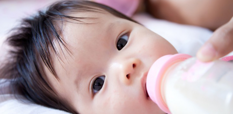 A baby is fed with a bottle